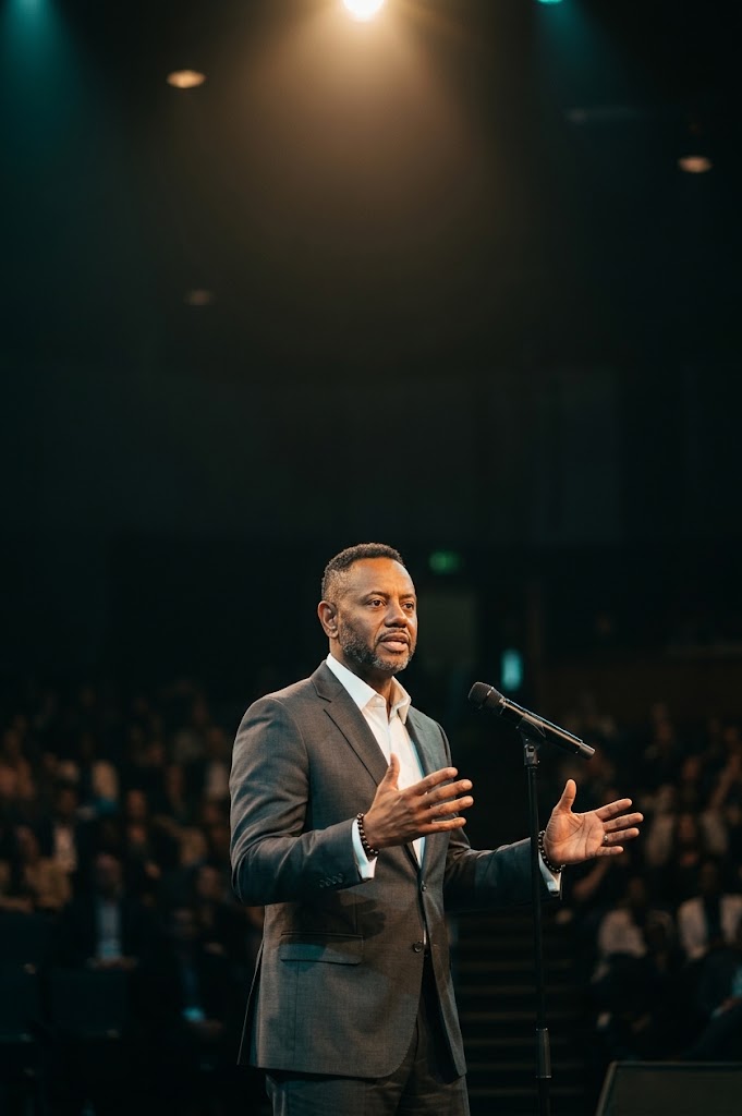 A.D. Roberts on stage addressing a live audience